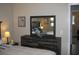 Cozy main bedroom featuring a rustic dresser with large mirror and a comfortable bed at 9911 Dahlia N St # 38, Pinellas Park, FL 33782