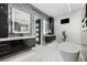 Sleek bathroom with modern fixtures, dark wood cabinetry, and a luxurious soaking tub at 10100 Tarpon Dr, Treasure Island, FL 33706