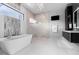 Bright bathroom with a modern tub, glass shower, and vanity with dark wood cabinets at 10100 Tarpon Dr, Treasure Island, FL 33706