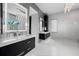 Sleek bathroom with dual vanities, modern lighting, and a spacious glass-enclosed shower at 10100 Tarpon Dr, Treasure Island, FL 33706