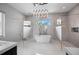 Luxurious bathroom featuring a freestanding tub, glass shower, and modern fixtures at 10100 Tarpon Dr, Treasure Island, FL 33706