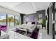 Modern bedroom with a large window showcasing scenic water views and stylish furnishings at 10100 Tarpon Dr, Treasure Island, FL 33706