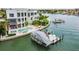 Elegant waterfront home with a private dock, boat lift, pool, and lush landscaping at 10100 Tarpon Dr, Treasure Island, FL 33706