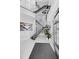 Bright foyer featuring a contemporary staircase with stainless steel railings, modern art, and high ceilings at 10100 Tarpon Dr, Treasure Island, FL 33706