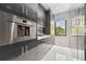 Modern kitchen features stainless steel appliances and custom gray cabinetry at 10100 Tarpon Dr, Treasure Island, FL 33706