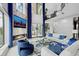 A bright living room featuring large windows, a fireplace, modern decor, and views of the waterway at 10100 Tarpon Dr, Treasure Island, FL 33706