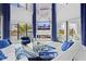 Bright living room with a fireplace, a large TV, and luxurious seating, offering stunning water views at 10100 Tarpon Dr, Treasure Island, FL 33706