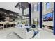 An open-concept living room with floor-to-ceiling windows, a fireplace, and stylish modern furniture at 10100 Tarpon Dr, Treasure Island, FL 33706