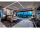 Luxurious main bedroom with floor-to-ceiling windows offering captivating water views at 10100 Tarpon Dr, Treasure Island, FL 33706