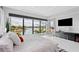 Beautifully decorated main bedroom with large windows overlooking serene waterfront scenery at 10100 Tarpon Dr, Treasure Island, FL 33706