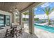 Dine in style with a covered outdoor dining area and views of the waterfront and swaying palm trees at 10100 Tarpon Dr, Treasure Island, FL 33706