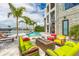 Entertain on this luxurious patio with comfortable seating, fire pit, and views of the pool and waterfront at 10100 Tarpon Dr, Treasure Island, FL 33706