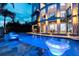 The pool is the centerpiece of outdoor relaxation and evening ambiance with custom lighting at 10100 Tarpon Dr, Treasure Island, FL 33706