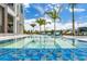 Enjoy a beautiful pool with mosaic tile accents and relaxing lounge chairs near the waterfront at 10100 Tarpon Dr, Treasure Island, FL 33706
