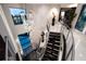 Modern staircase featuring black wood treads, metal railings, and high ceilings at 10100 Tarpon Dr, Treasure Island, FL 33706