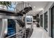 Modern staircase featuring black wood treads, metal railings, and high ceilings at 10100 Tarpon Dr, Treasure Island, FL 33706