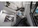 Modern staircase with metal railings and an open design showcasing artwork at 10100 Tarpon Dr, Treasure Island, FL 33706