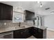 Well-lit kitchen showcasing granite countertops, modern backsplash, dark wood cabinets, and a breakfast bar at 10246 Bannister St, Spring Hill, FL 34608