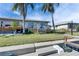 Waterfront home featuring a wooden deck and dock with beautiful landscaping and a picturesque outdoor space at 1025 Apollo Beach Blvd # 1, Apollo Beach, FL 33572