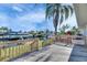 Backyard wood deck showcasing waterfront view and vibrant palm trees on a sunny day at 1025 Apollo Beach Blvd # 1, Apollo Beach, FL 33572
