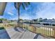 Backyard wood deck showcasing waterfront view, docks and vibrant palm trees on a sunny day at 1025 Apollo Beach Blvd # 1, Apollo Beach, FL 33572