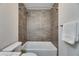 Elegant bathroom with a tiled shower-bathtub, modern fixtures, and neutral color palette exudes a sense of relaxation at 1025 Apollo Beach Blvd # 1, Apollo Beach, FL 33572