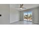 Bedroom showing a ceiling fan and sliding glass doors to a patio overlooking the water at 1025 Apollo Beach Blvd # 1, Apollo Beach, FL 33572