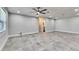 Spacious bedroom with a ceiling fan, tile floors, and ensuite bathroom entrance at 1025 Apollo Beach Blvd # 1, Apollo Beach, FL 33572