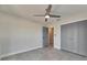 An airy bedroom features a ceiling fan and tiled floor, with closet and access door at 1025 Apollo Beach Blvd # 1, Apollo Beach, FL 33572