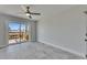 A bedroom features a ceiling fan and sliding glass doors to a wood deck at 1025 Apollo Beach Blvd # 1, Apollo Beach, FL 33572