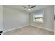 Bright bedroom featuring a ceiling fan, window, and grey tile flooring providing a comfortable living space at 1025 Apollo Beach Blvd # 1, Apollo Beach, FL 33572
