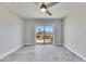 A bedroom features a ceiling fan and sliding glass doors to a deck overlooking the water at 1025 Apollo Beach Blvd # 1, Apollo Beach, FL 33572