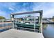 Waterfront property featuring a boat lift on a canal in a backyard at 1025 Apollo Beach Blvd # 1, Apollo Beach, FL 33572