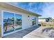 Exterior shot highlighting the back of the house and outdoor deck with sliding glass doors at 1025 Apollo Beach Blvd # 1, Apollo Beach, FL 33572