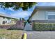 Property exterior featuring a sidewalk entrance between brick fences and manicured landscaping at 1025 Apollo Beach Blvd # 1, Apollo Beach, FL 33572