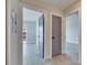 Hallway with grey doors, grey tiling and white trim, offering multiple access points to different rooms at 1025 Apollo Beach Blvd # 1, Apollo Beach, FL 33572
