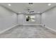 Living room with a ceiling fan, tile floors, bright window, and a white door at 1025 Apollo Beach Blvd # 1, Apollo Beach, FL 33572