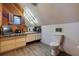 Angled wood paneled bathroom with tiled countertop, modern lighting, and vinyl flooring at 1130 Serpentine S Dr, St Petersburg, FL 33705
