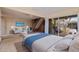 Bright bedroom featuring a sitting area, wood stairs and sliding glass doors to a deck with a hammock at 1130 Serpentine S Dr, St Petersburg, FL 33705