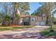Two story home with a two car garage and a brick driveway surrounded by lush landscaping at 1130 Serpentine S Dr, St Petersburg, FL 33705