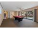 Bright game room featuring a pool table and access to the backyard pool at 1130 Serpentine S Dr, St Petersburg, FL 33705