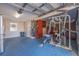 Garage features gym equipment, overhead storage, and a side door at 1130 Serpentine S Dr, St Petersburg, FL 33705
