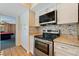 Updated kitchen with stainless steel appliances and tiled backsplash at 1130 Serpentine S Dr, St Petersburg, FL 33705