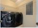 Laundry room featuring front-load washer and dryer, and wire shelving at 1130 Serpentine S Dr, St Petersburg, FL 33705