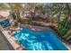 Backyard oasis with a sparkling blue pool surrounded by brick pavers and lush landscaping at 1130 Serpentine S Dr, St Petersburg, FL 33705