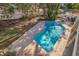 Backyard with a pool, mature trees, and an outdoor seating area at 1130 Serpentine S Dr, St Petersburg, FL 33705