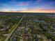 Stunning sunset aerial view of a sprawling residential community with lakes and tree-lined streets against a vibrant sky at 11611 Jordans Landing Ct, Riverview, FL 33569