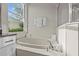 Bright bathroom featuring a garden tub with chrome fixtures, white towels, and a sunny window at 11611 Jordans Landing Ct, Riverview, FL 33569