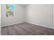 Bedroom with neutral walls, carpeting, and natural lighting through the single window at 11611 Jordans Landing Ct, Riverview, FL 33569
