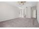 Large bedroom with neutral colors, tray ceiling, and ample space at 11611 Jordans Landing Ct, Riverview, FL 33569